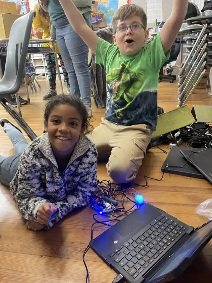 F26AEC47-563A-4188-B4DB-82863BCD010B Students celebrate successful project in class. (Merry Martin)